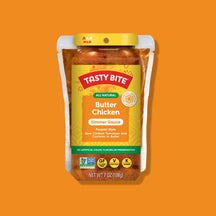 Tasty Bite Butter Chicken simmer sauce package on an orange background