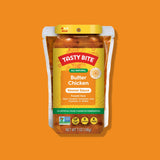 Tasty Bite Butter Chicken simmer sauce package on an orange background