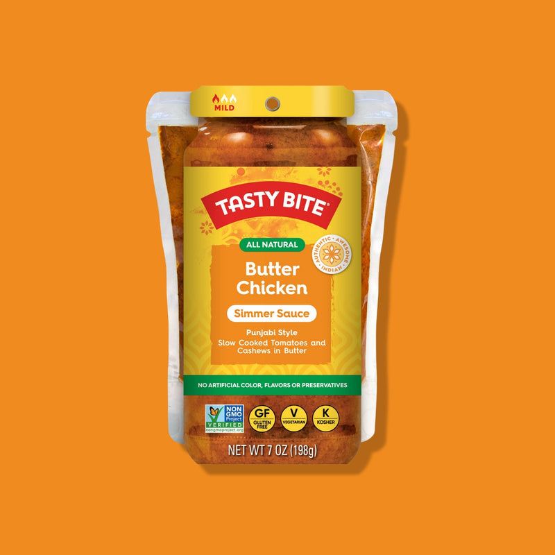 Tasty Bite Butter Chicken simmer sauce package on an orange background